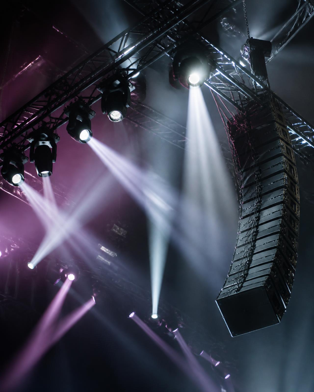 Stage truss with moving lights and a hanging line array