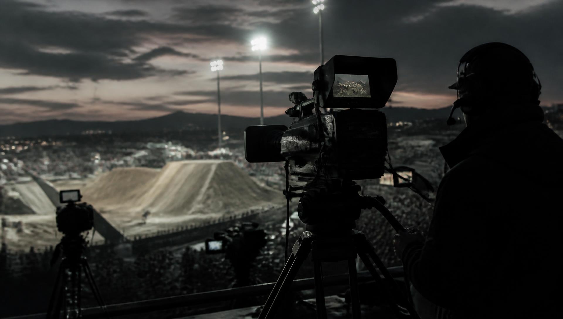 Broadcast camera operator covering an outdoor action sports event